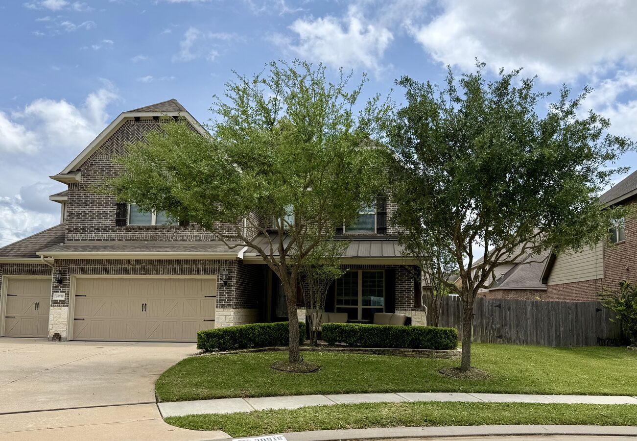 Suburban home after tree trimming — clean canopy, house fully visible